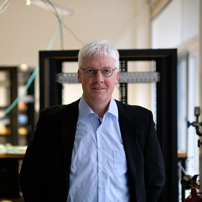 A white man standing in front of technologies